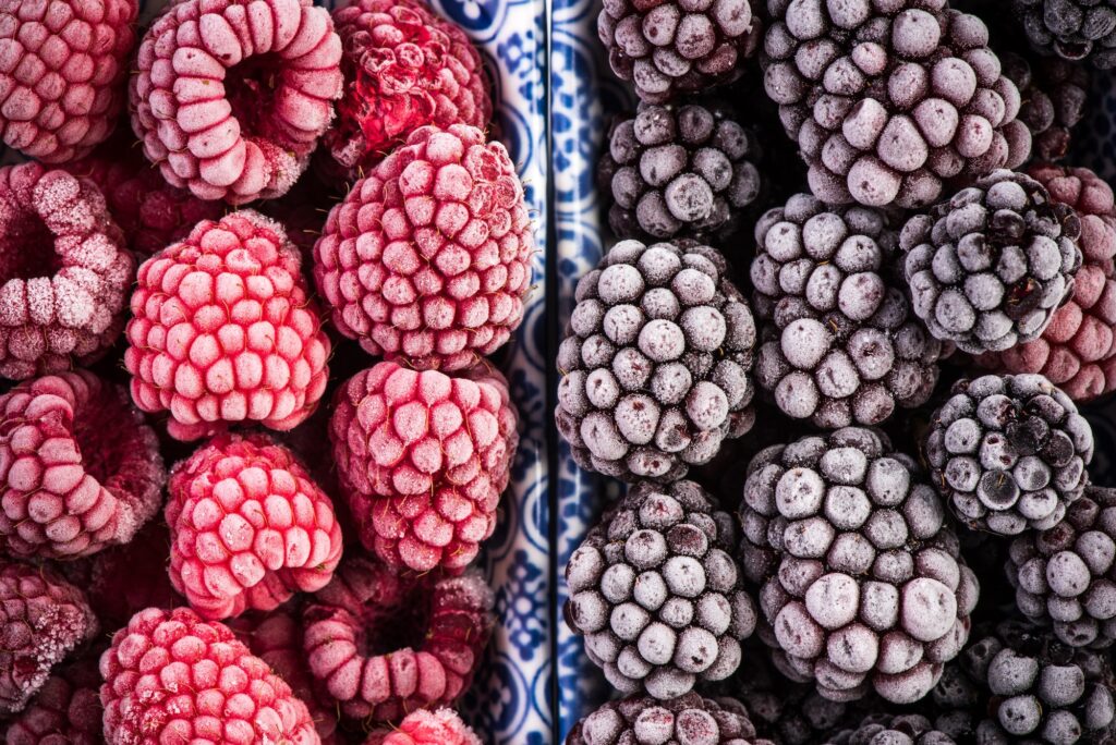 Frozen blackberry and raspberry fruits, close up